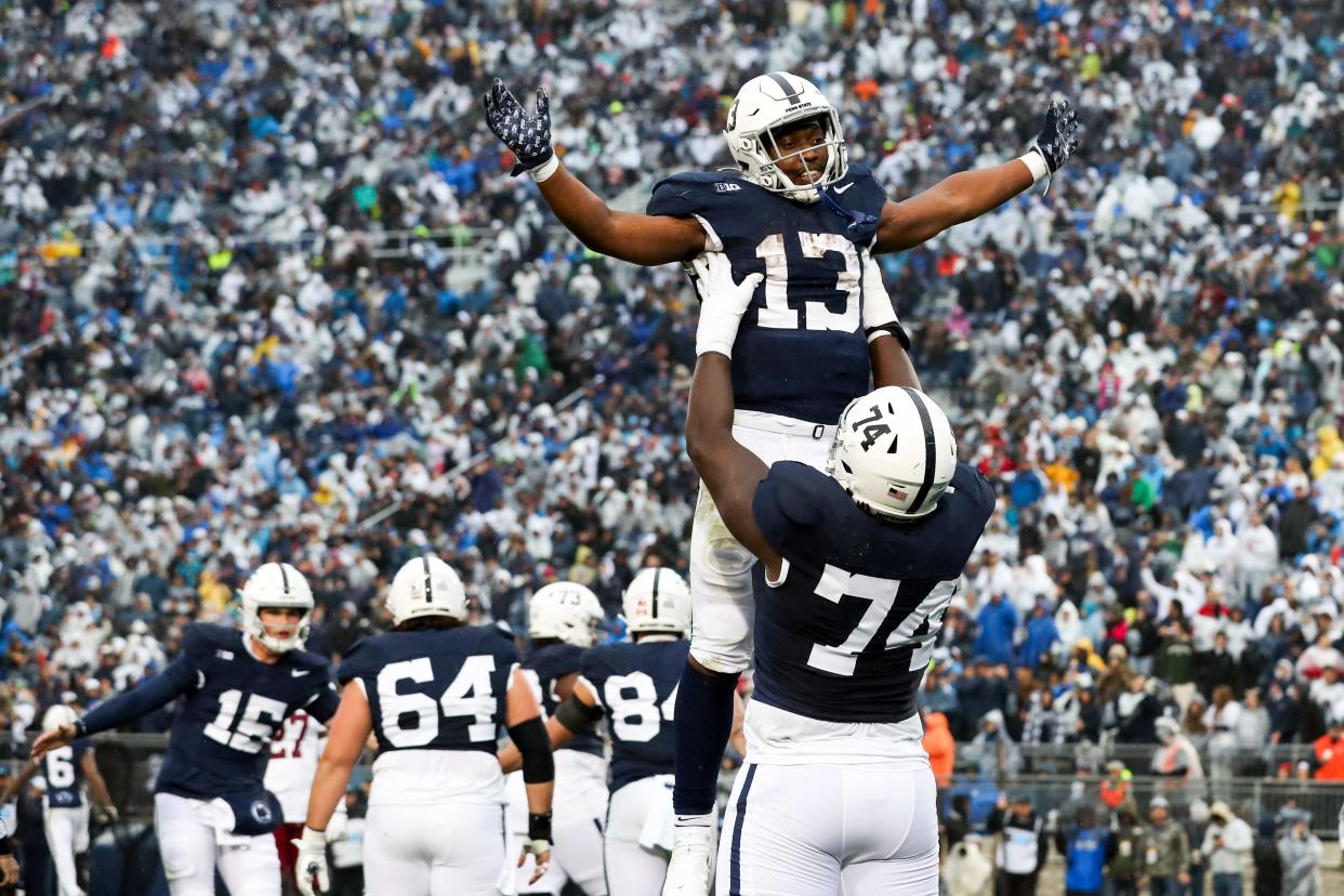 Oct 14, 2023; University Park, Pennsylvania, USA; Penn State Nittany Lions running back Kaytron Allen (13) celebrates with offensive linesman Olumuyiwa Fashanu (74) after scoring a touchdown during the second quarter against the Massachusetts Minutemen at Beaver Stadium. Mandatory Credit: Matthew O'Haren-USA TODAY Sports