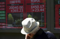 A man walks past an electronic stock board showing Japan's Nikkei 225 index at a securities firm in Tokyo Friday, May 8, 2020. Asian shares surged Friday on optimism the worst of the economic fallout from the pandemic may be over, as Wall Street logged its biggest rally in a week.(AP Photo/Eugene Hoshiko)