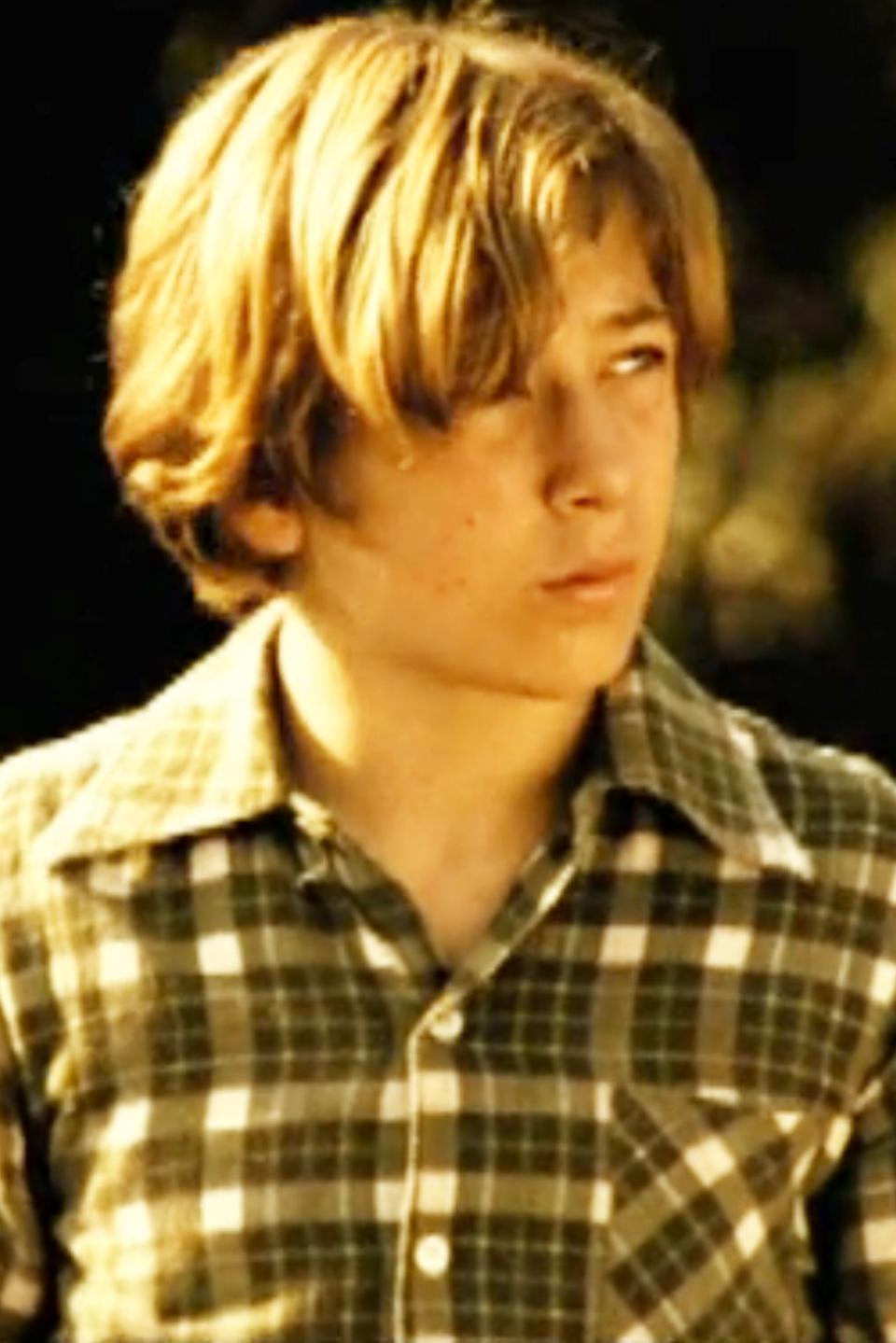 A young Jeremy Allen White in a plaid shirt