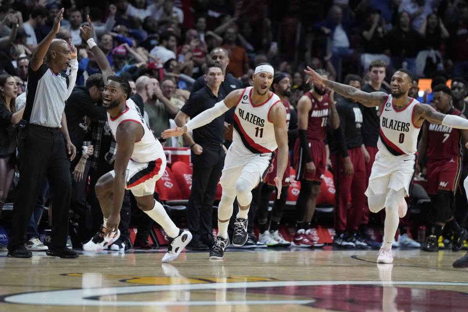 Portland Trail Blazers players celebrate after guard Josh Hart (11) made a three-point shot at the buzzer to win an NBA basketball game against the Miami Heat, 110-107, Monday, Nov. 7, 2022, in Miami. (AP Photo/Wilfredo Lee)
