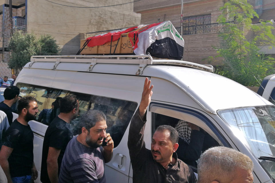 Mourners escort the flag-draped coffin of Mohammed Jassim, a protester killed in anti-government protests, during his funeral in Baghdad, Iraq, Friday, Nov. 15, 2019. Iraqi medical and security officials say one protester was killed and over 40 were wounded in renewed clashes overnight in central Baghdad. (AP Photo/Khalid Mohammed)