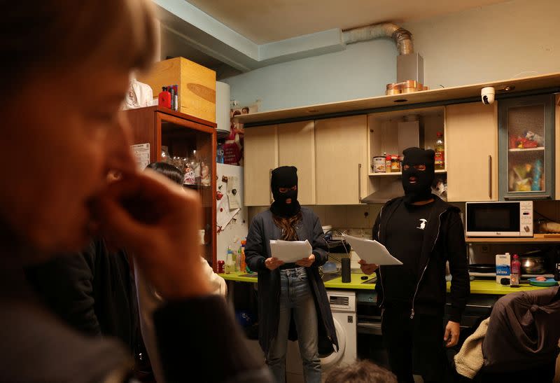 Artists recite poetry during a protest action in one of the apartments whose residents fear they will be evicted in the event of purchase of the whole building by a real estate investment fund, in Madrid
