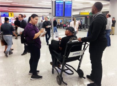 Emily Pagan, a New York state government official, greets and help orients people arriving from Puerto Rico and the U.S. Virgin Islands at John F. Kennedy International Airport in New York, U.S. October 19, 2017.  Photo taken October 19, 2017.  REUTERS/Jonathan Allen