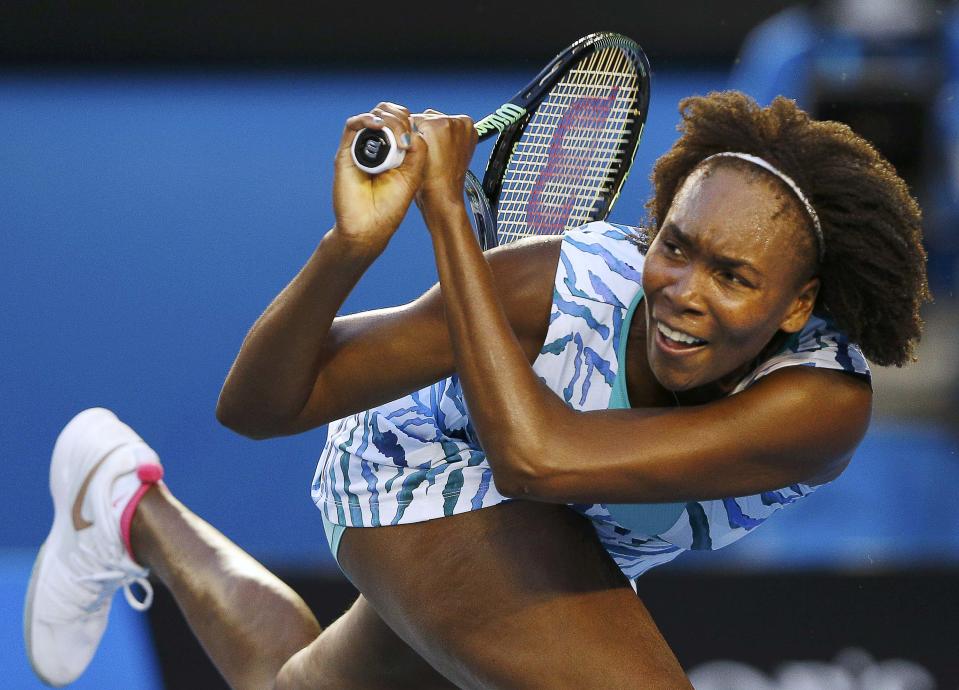 Venus of the U.S. hits a return to Radwanska of Poland during their women's singles match at the Australian Open 2015 tennis tournament in Melbourne