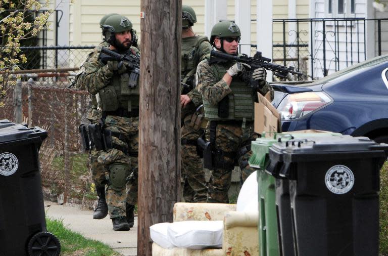 Police conduct a door-to-door search for 19-year-old Boston Marathon bombing suspect Dzhokhar Tsarnaev on Francis Street April 19, 2013 in Watertown, Massachusetts