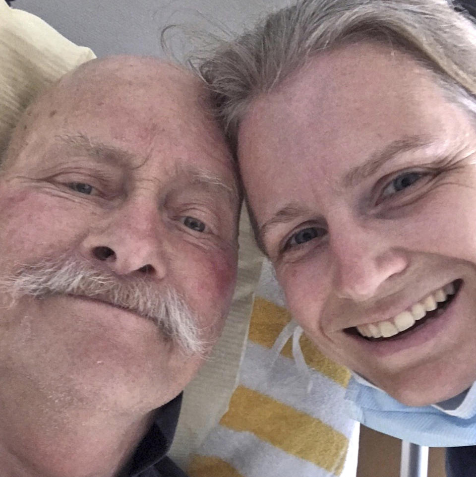 In this photo released by Astrid Magenau, Magenau poses for a photo with her father in Stuttgart, Germany on June 6, 2020. Magenau wasn’t able to keep a promise to hold her father’s hand at his deathbed in Germany because of Australia’s extraordinary pandemic restrictions that make her feel like a prisoner in her adopted country. (Astrid Magenau via AP)