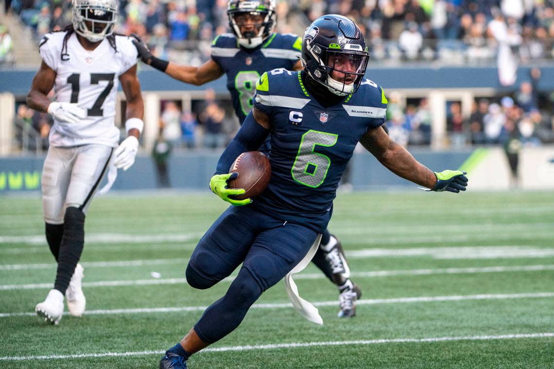 Seattle Seahawks safety Quandre Diggs (6) runs back an interception by Las Vegas Raiders quarterback Derek Carr (4) during the first quarter of an NFL game on Sunday, Nov. 27, 2022, at Lumen Field in Seattle.