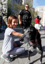 <p>Grace Baker, 10, pets Bila, a K-9 with the Los Angeles International Airport Police, as handler Robert Corchado looks at Public Square, Wednesday, July 20, 2016, in Cleveland, during the third day of the Republican convention. (AP Photo/Alex Brandon)</p>