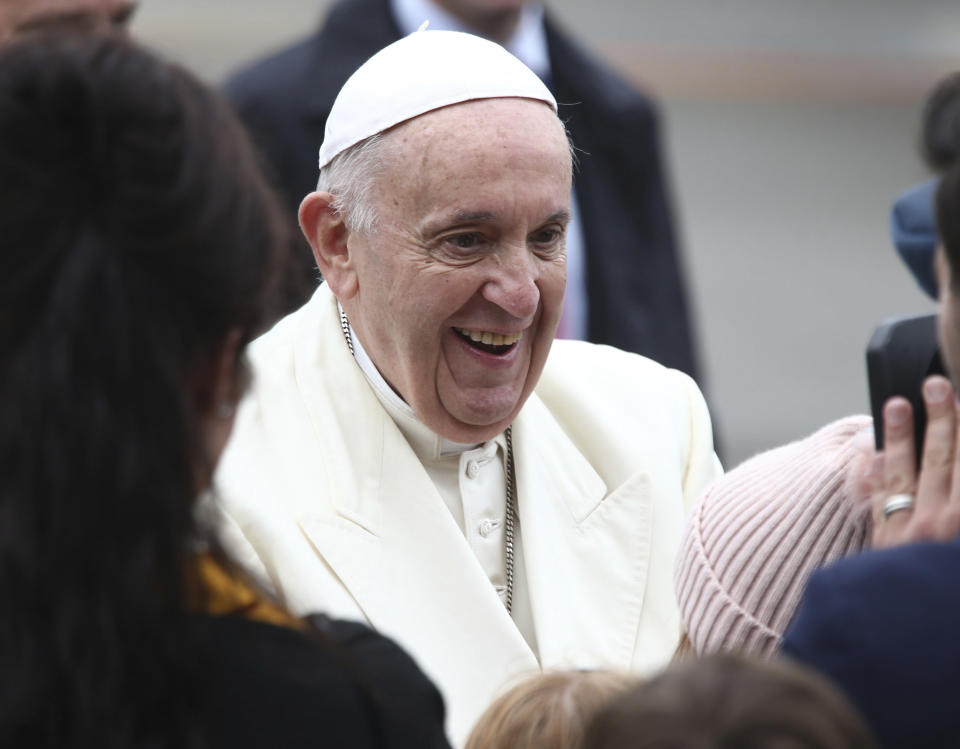 Pope Francis greets children as he disembarks from an airplane at Knock's airport, Ireland, where he will visit the Knock Shrine and recite an angelus prayer, Sunday, Aug. 26, 2018. Pope Francis is on a two-day visit to Ireland. (Yui Mok/PA via AP)