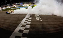 RICHMOND, VA - APRIL 28: Kyle Busch, driver of the #18 M&M's Ms. Brown Toyota, celebrates with a burnout after winning the NASCAR Sprint Cup Series Capital City 400 at Richmond International Raceway on April 28, 2012 in Richmond, Virginia. (Photo by Tom Pennington/Getty Images for NASCAR)