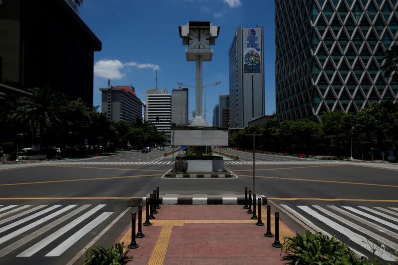 FILE PHOTO: An almost empty intersection with low traffic is seen at noon on Jalan M.H. Thamrin, one of the main roads in Jakarta, during the coronavirus disease (COVID-19) outbreak, in Jakarta