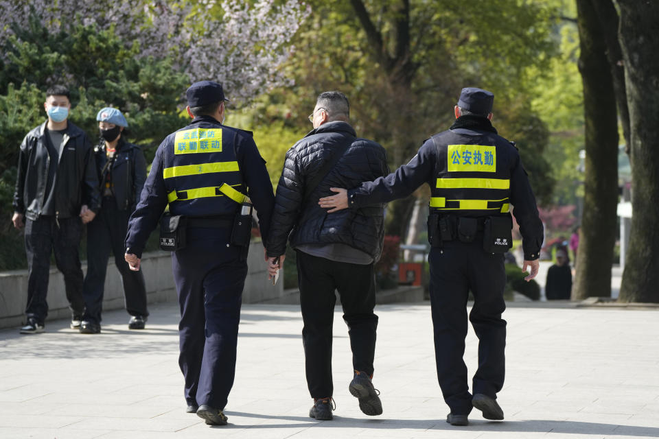 A man is taken away after he shouted in anger for being denied entry to the Mausoleum of Sun Yat-sen which was closed off for a visit by former Taiwan President Ma Ying-jeou, in Nanjing, in eastern China's Jiangsu province, Tuesday, March 28, 2023. Ma has departed for a tour of China in what he calls an attempt to reduce tensions a day after Taiwan lost one of its few remaining diplomatic partners to China. (AP Photo/Ng Han Guan)