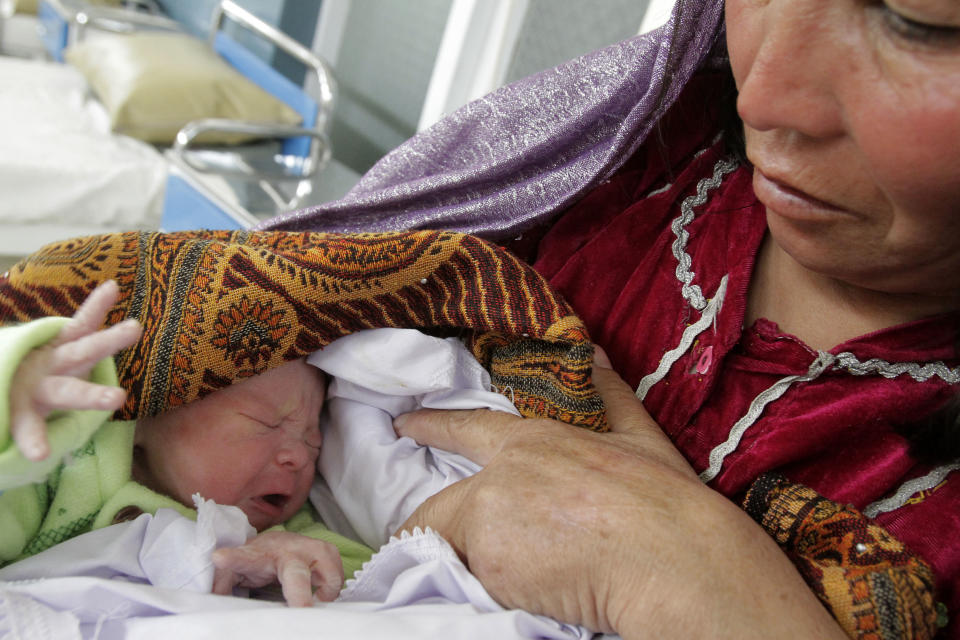 An Afghan mother shows off her 3-hour-old baby in the maternity ward of Ahmad Shah Baba District Hospital in Kabul, Afghanistan on Monday, Feb. 24. 2014. (AP Photo/Cassandra Vinograd)