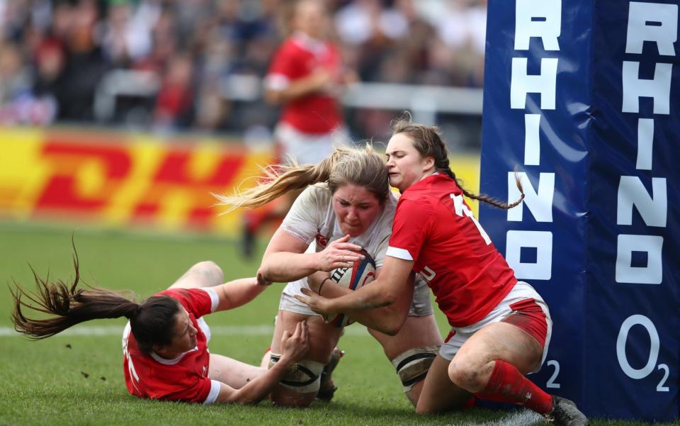 Poppy Cleall of England beats Kayleigh Powell and Lisa Neumann of Wales to score her third try during the Women's Six Nations match between England and Wales at Twickenham Stoop on March 07, 2020 in London, England - Getty Images Europe /Michael Steele 