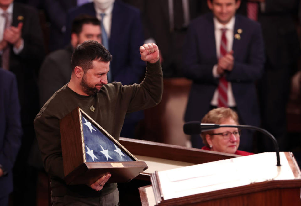 President of Ukraine Volodymyr Zelensky holds an American flag gifted to him by U.S. Speaker of the House Nancy Pelosi as he addresses a joint meeting of Congress in the House Chamber of the U.S. Capitol on Dec. 21, 2022, in Washington, D.C.