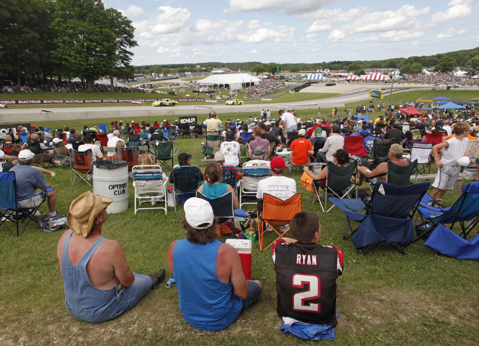 FILE - Fans watch the Bucyrus 200 NASCAR Nationwide series race at Road America in Elkhart Lake, Wi., in this Saturday, June, 19, 2010, file photo. For all its history, Road America only hosted NASCAR’s premier series once before, when Tim Flock won a rainy Grand National event back in 1956. That changes Sunday on the Fourth of July -- a coup for a facility that bills itself as “America’s national park for speed” but until this year couldn’t land a Cup date. (AP Photo/Jeffrey Phelps, File)