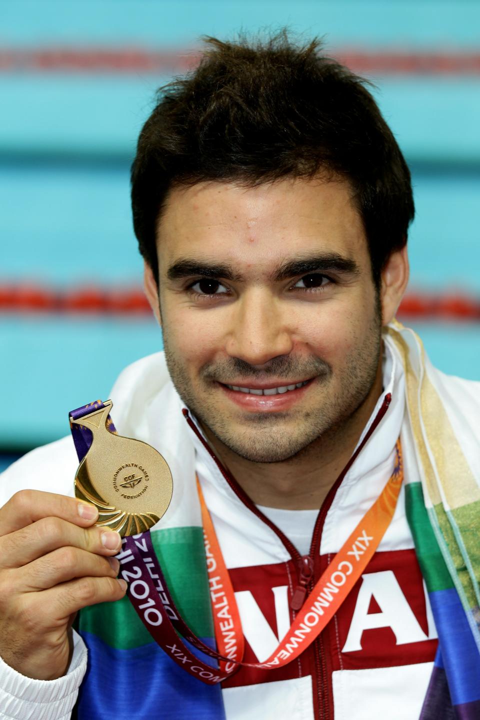 DELHI, INDIA - OCTOBER 11: Alexandre Despatie of Canada poses with the gold medal won in the Men's 3m Springboard Final at Dr. S.P. Mukherjee Aquatics Complex during day eight of the Delhi 2010 Commonwealth Games on October 11, 2010 in Delhi, India. (Photo by Matt King/Getty Images)