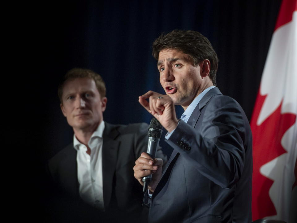 Liberal Party, of Canada Leader Justin Trudeau, speaks to supporters as Marc Miller, MP of Ville-Marie-Le Sud-Ouest-Ile-des-Soeurs, looks on during an armchair discussion at an open Liberal Party fundraising event in Montreal, Quebec, Monday, June 17, 2019. (Peter McCabe/The Canadian Press via AP)