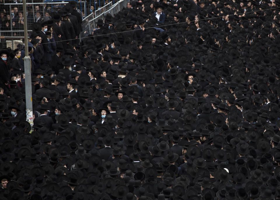 Thousands of ultra-Orthodox Jews participate in the funeral for prominent rabbi Meshulam Soloveitchik, in Jerusalem, Sunday, Jan. 31, 2021. The mass ceremony took place despite the country's health regulations banning large public gatherings, during a nationwide lockdown to curb the spread of the coronavirus. (AP Photo/Ariel Schalit)