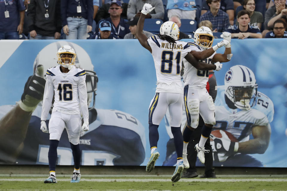 Los Angeles Chargers running back Austin Ekeler, right, celebrates with Mike Williams (81) after Ekeler scored a touchdown against the Tennessee Titans on a 41-yard pass play in the fourth quarter of an NFL football game Sunday, Oct. 20, 2019, in Nashville, Tenn. (AP Photo/James Kenney)