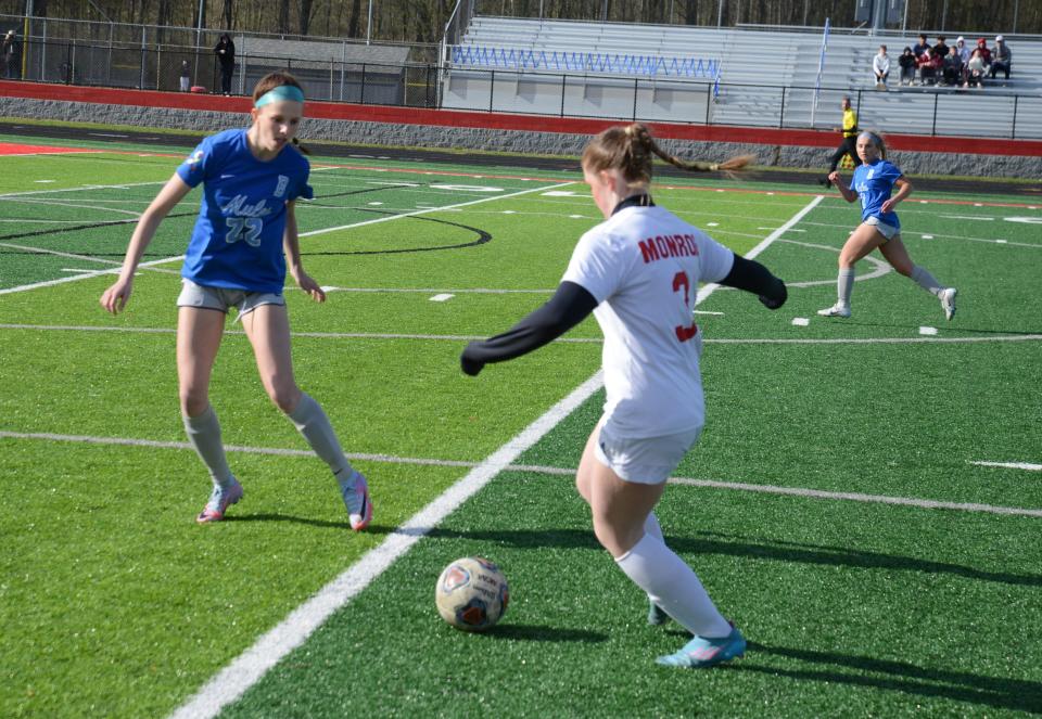 Monroe's Rowan Stamper is guarded by Lexi Ripple of Bedford Tuesday. Stamper scored twice during a 3-0 Monroe victory. Bedford was wearing blue for Autism Awareness Day.