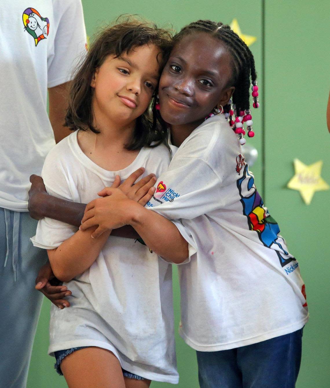 Gia, left, and Phaedra hug at Camp U.O.T.S. on July 23.