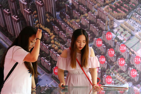 Visitors are seen at a real estate fair during the National Day "Golden Week" holiday in Huaian, Jiangsu province, China October 7, 2018. Picture taken October 7, 2018. REUTERS/Stringer