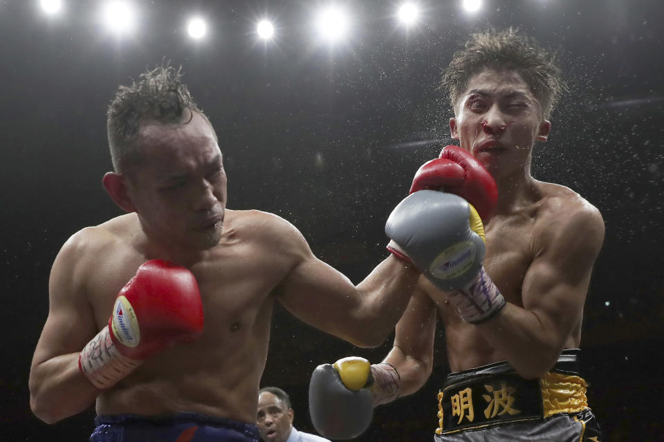 Japan's Naoya Inoue, right, gets a punch from Philippines' Nonito Donaire in the 11th round of their World Boxing Super Series bantamweight final match in Saitama, Japan, Thursday, Nov. 7, 2019. Inoue beat Donaire with a unanimous decision to win the championship. (AP Photo/Toru Takahashi)