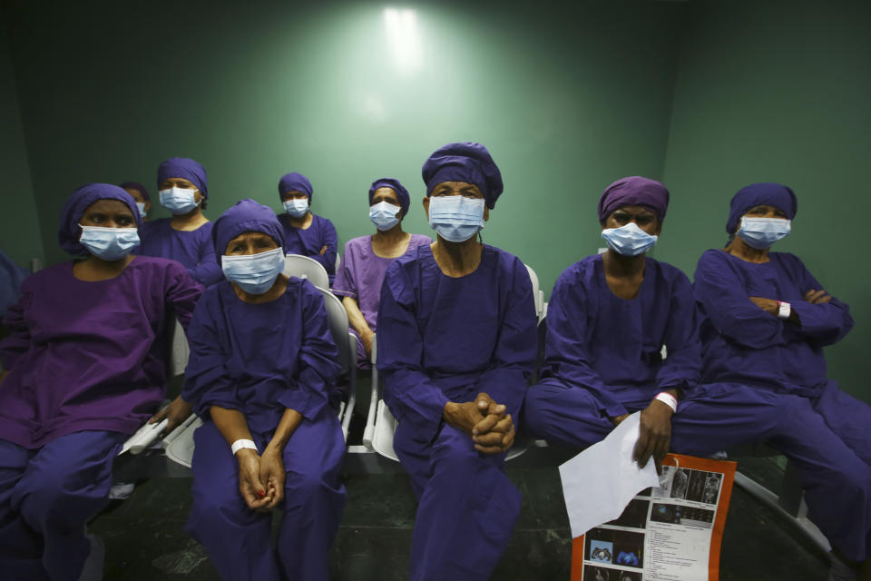 Nepalese patients wait to receive anesthesia before eye surgery at the Tilganga Eye Center in Kathmandu, Nepal, Friday, March 26, 2021. Nepal’s “God of Sight” eye doctor renowned for his innovative and inexpensive cataract surgery for the poor is taking his work beyond the Himalayan mountains to other parts of the world so there is no more unnecessary blindness in the world. Dr. Sanduk Ruit, who has won many awards for his work and performed some 130,000 cataract surgery in the past three decades, is aiming to expand his work beyond the borders of his home country and the region to go globally. (AP Photo/Niranjan Shrestha)