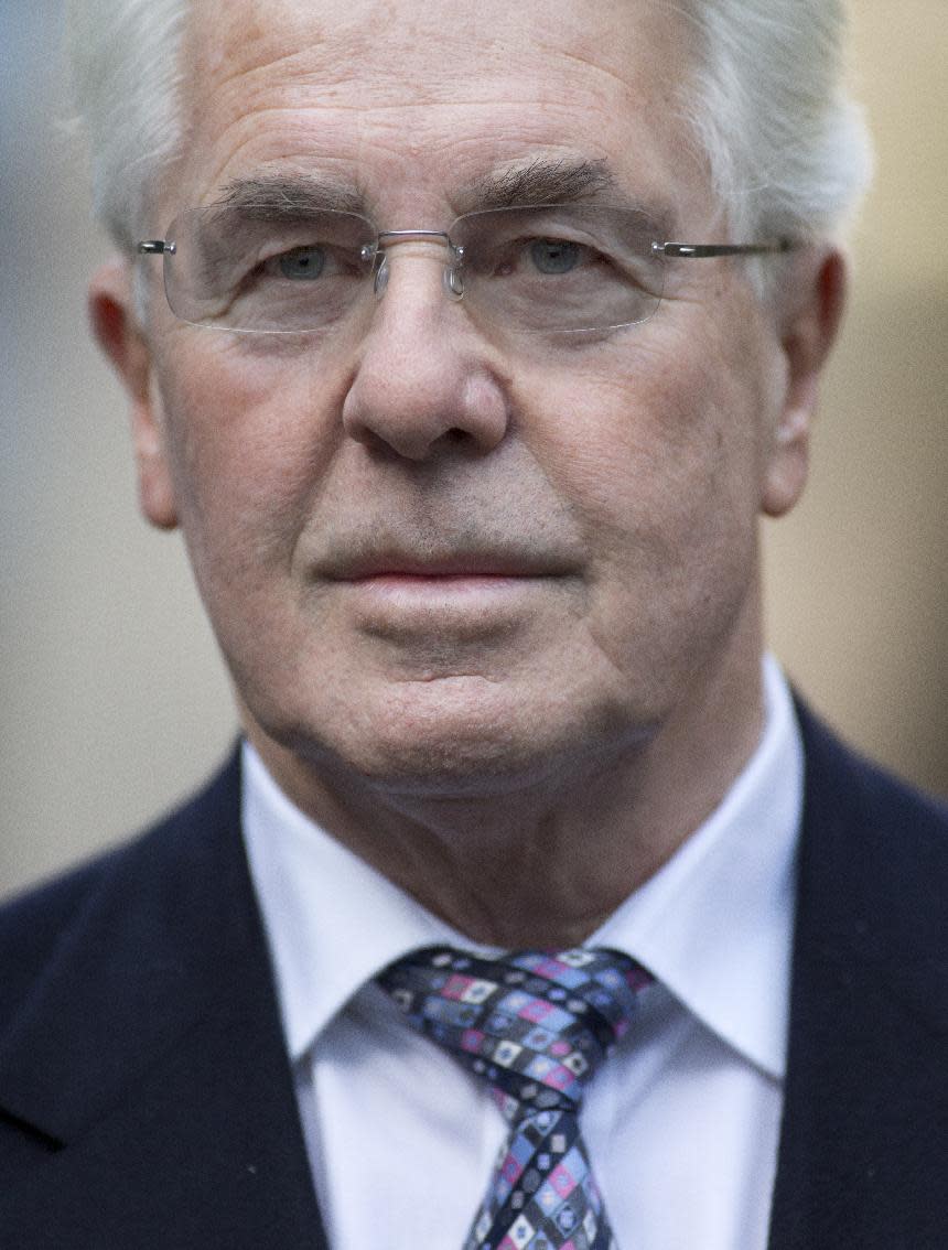 British public relations guru Max Clifford poses for the media as he arrives at Southwark Crown Court in London for jury selection before his trial on charges of indecent assault, Wednesday, March 5, 2014. Clifford faces 11 counts of indecent assault on 7 alleged teenagers between 1966 and 1984. (AP Photo/Alastair Grant)