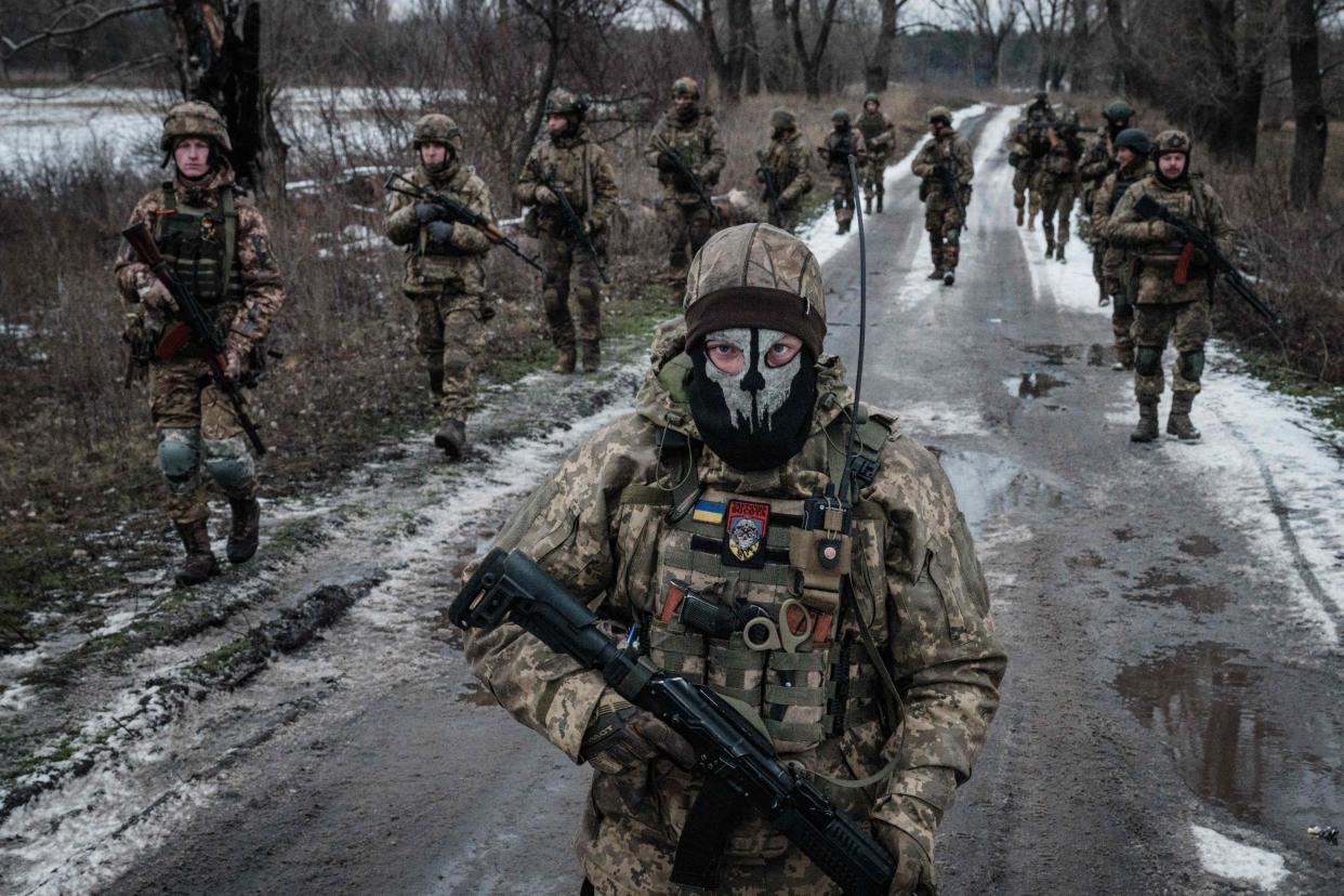 Ukrainian servicemen walk on the road toward their base near the frontline in the Donetsk region (AFP via Getty Images)