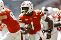 Miami quarterback D'Eriq King (1) runs with the ball during the first quarter of an NCAA college football game against Michigan State, Saturday, Sept. 18, 2021, in Miami Gardens, Fla. (AP Photo/Michael Reaves)