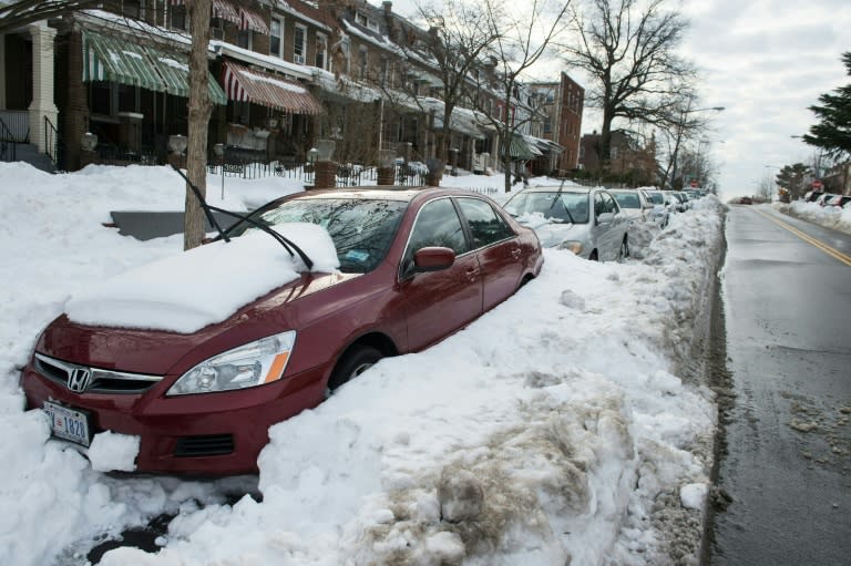 Cars are stuck in snow along a street in Washington, DC, on January 26, 2016