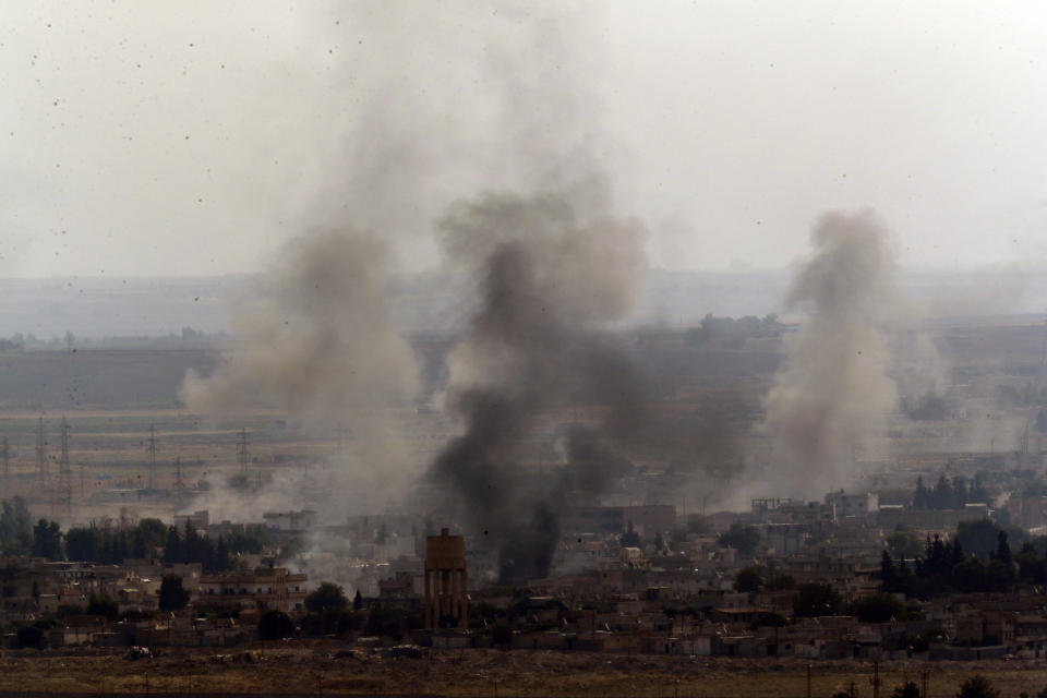 In this photo taken from the Turkish side of the border between Turkey and Syria, in Ceylanpinar, Sanliurfa province, southeastern Turkey, smoke billows from targets in Ras al-Ayn, Syria, caused by shelling by Turkish forces, Thursday, Oct. 17, 2019. U.S. Vice President Mike Pence and State Secretary Mike Pompeo were scheduled to arrive in Ankara and press Turkey's President Recep Tayyip Erdogan to accept a ceasefire in northeast Syria. (AP Photo/Lefteris Pitarakis)