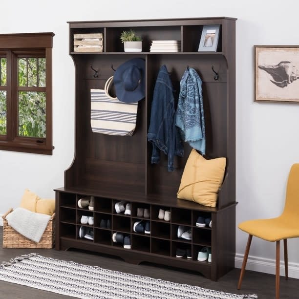 a wide hall tree with 24 shoe cubbies