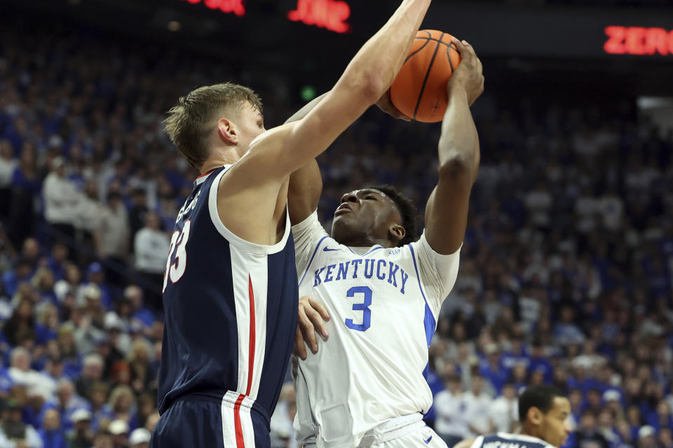 Kentucky's Adou Thiero (3) has his shot pressured by Gonzaga's Ben Gregg, left, during the first half of an NCAA college basketball game Saturday, Feb. 10, 2024, in Lexington, Ky. (AP Photo/James Crisp)