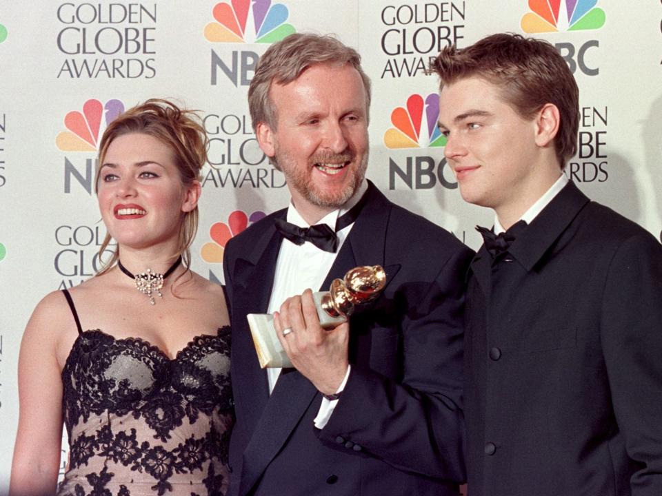Director James Cameron and actress Kate Winslet and actor Leonardo DiCapri pose for photographers after Cameron won the award for Best Director for "Titanic" at the 55th Annual Golden Globe Awards.