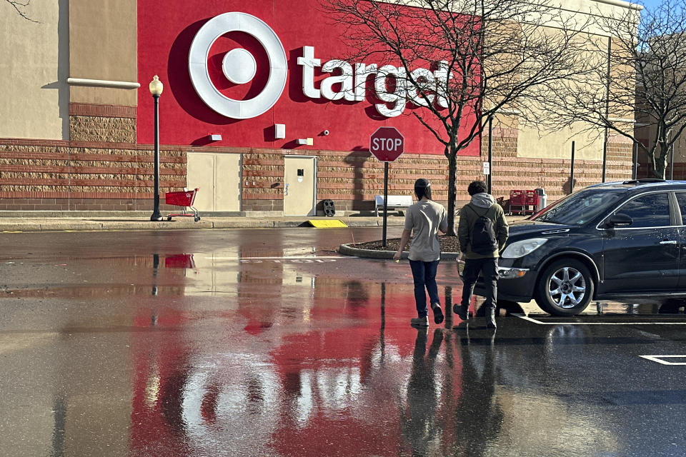 FILE - People walk towards a Target store in Clifton, N.J., on December 18, 2023. Retailers, including Walmart and Target, are stepping up discounting heading into the summer of 2024, as they hope to offer frustrated shoppers some relief from higher prices and entice them to open their wallets. (AP Photo/Ted Shaffrey)