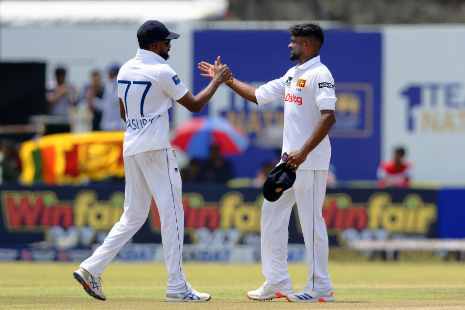 Sri Lanka's Ramesh Mendis, right, and teammate Prabath Jayasuriya celebrate the wicket of New Zealand's William O'Rourke on the third day of the first cricket test match between New Zealand and Sri Lanka in Galle, Sri Lanka, Friday, Sept. 20, 2024. (AP Photo/Viraj Kothalawala)