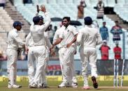 Cricket - India v New Zealand - Second Test cricket match - Eden Gardens, Kolkata, India - 01/10/2016. India's Bhuvneshwar Kumar celebrates with teammates after taking the wicket of New Zealands' Henry Nicholls. REUTERS/Rupak De Chowdhuri