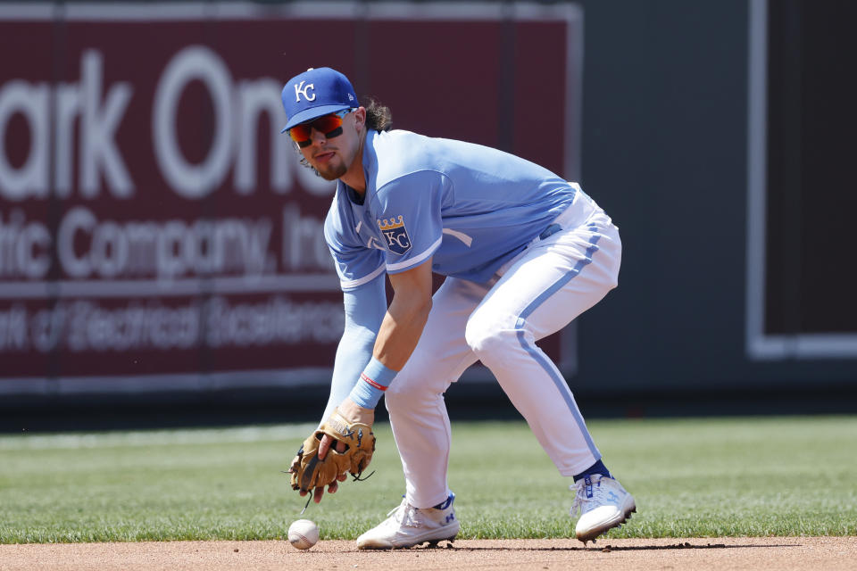 Kansas City Royals shortstop Bobby Witt Jr. drops the ball after fielding a ground ball by Colorado Rockies batter Jurickson Profar during the first inning of a baseball game in Kansas City, Mo., Saturday, June 3, 2023. Profar was safe at first base and Witt was charged with an error on the play. (AP Photo/Colin E. Braley)