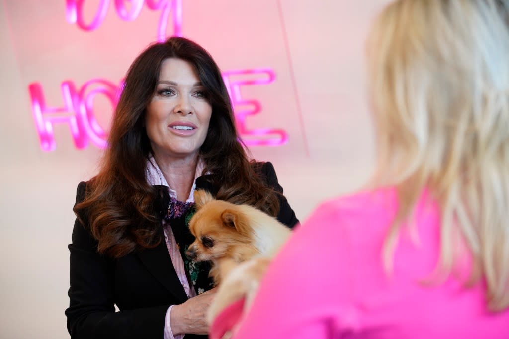 Lisa Vanderpump holding a dog and talking to a customer on Peacock's Vanderpump Dogs.