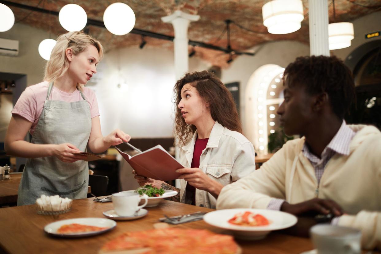 disgruntled restaurant guest talking to waitress