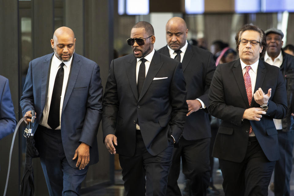 R. Kelly walks with attorneys and supporters into the Leighton Criminal Courthouse, Friday, March 22, 2019 in Chicago. (Ashlee Rezin/Chicago Sun-Times via AP)