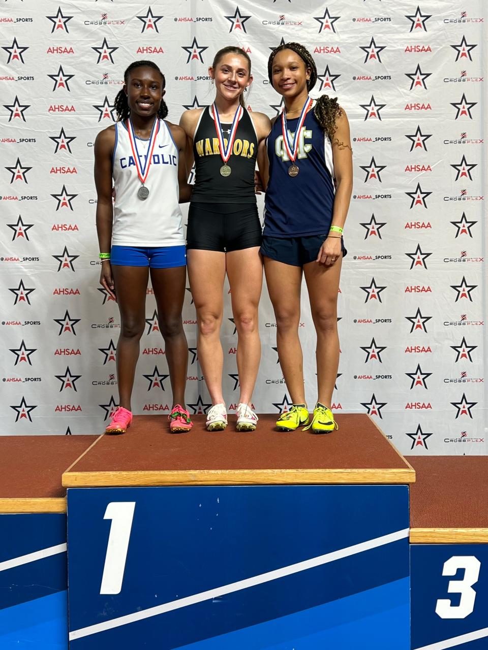 Cherokee County's Mary Hayes Johnson poses on the podium, after winning two state titles at the AHSAA indoor track meet.