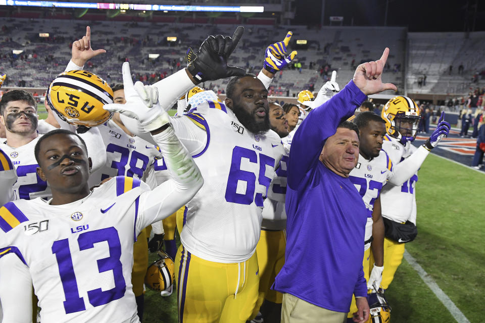 LSU head coach Ed Orgeron and players celebrate after an NCAA college football game against Mississippi in Oxford, Miss., Saturday, Nov. 16, 2019. No. 1 LSU won 58-37. (AP Photo/Thomas Graning)