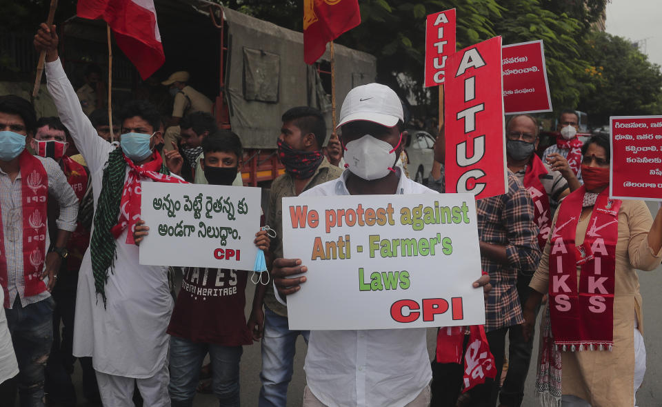 Members of All India Kisan Sangharsh Coordination Committee (AIKSCC) and activists of left parties and trade unions participate in a nationwide protest in Hyderabad, India, Friday, Sept. 25, 2020. Hundreds of Indian farmers took to the streets on Friday protesting new laws that the government says will boost growth in the farming sector through private investments, but they fear these are likely to be exploited by private players for buying their crops cheaply. (AP Photo/Mahesh Kumar A.)