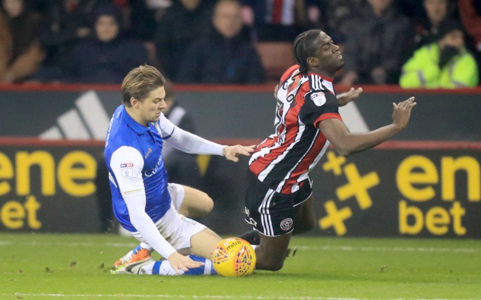 Wednesday's Glenn Loovens hacks down United's Clayton Donaldson and is sent off in the Sheffield derby - PA