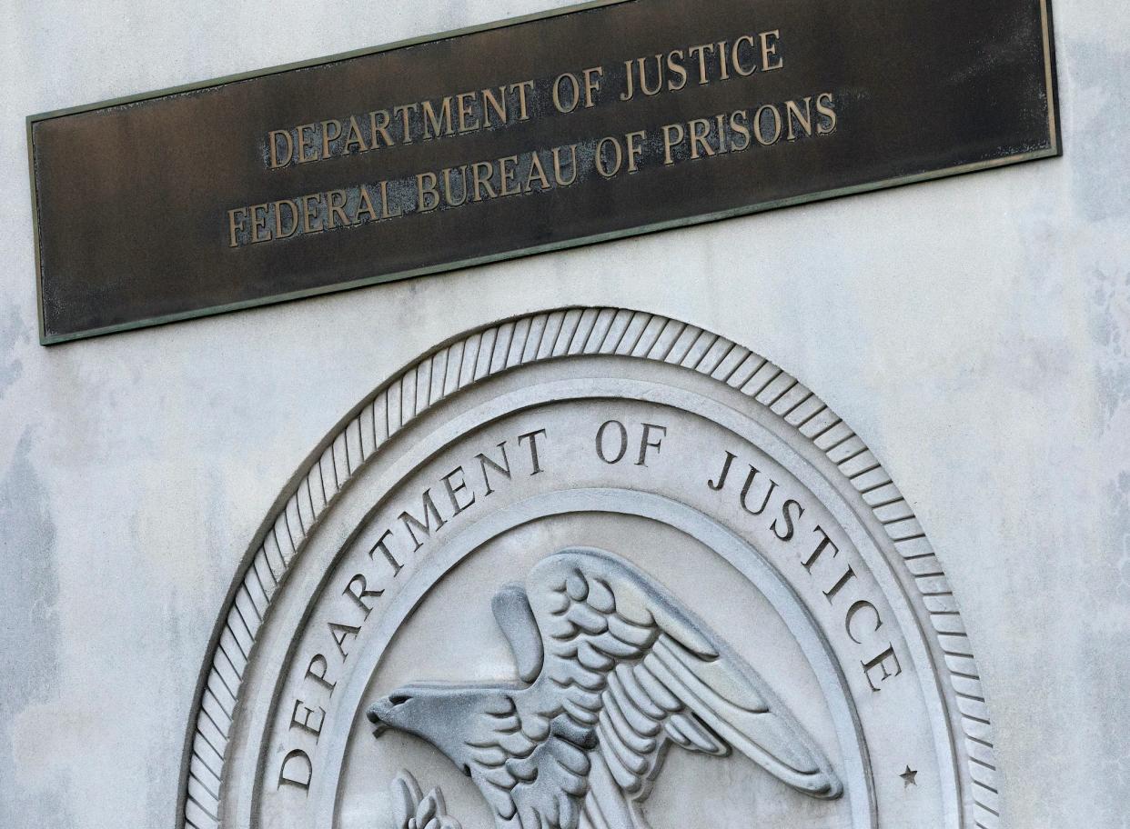 A sign for the Department of Justice Federal Bureau of Prisons.