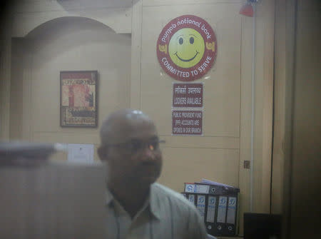 A Central Bureau of Investigation (CBI) official is seen inside a Punjab National Bank branch in Mumbai, India, February 19, 2018. REUTERS/Francis Mascarenhas